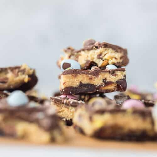 Mini egg cookie dough date bark layered with Medjool dates, cookie dough, chocolate, and crushed mini eggs