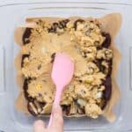 Spreading cookie dough evenly over flattened date base