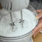 beat marshmallow mixture until it becomes thick and fluffy and the mixing bowl is cool to the touch.
