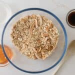oats, puffed quinoa, nuts, coconut, and all seeds mixed together in large mixing bowl for granola