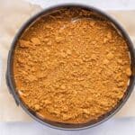 High Protein No Bake Biscoff Cheesecake topped with melted Biscoff spread and crushed cookie crumbs