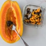 papaya sliced in half with seeds removed.