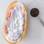 yogurt and chia seeds added to papaya bowl