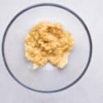 Mashed bananas in bowl for fudgy banana chocolate cookies