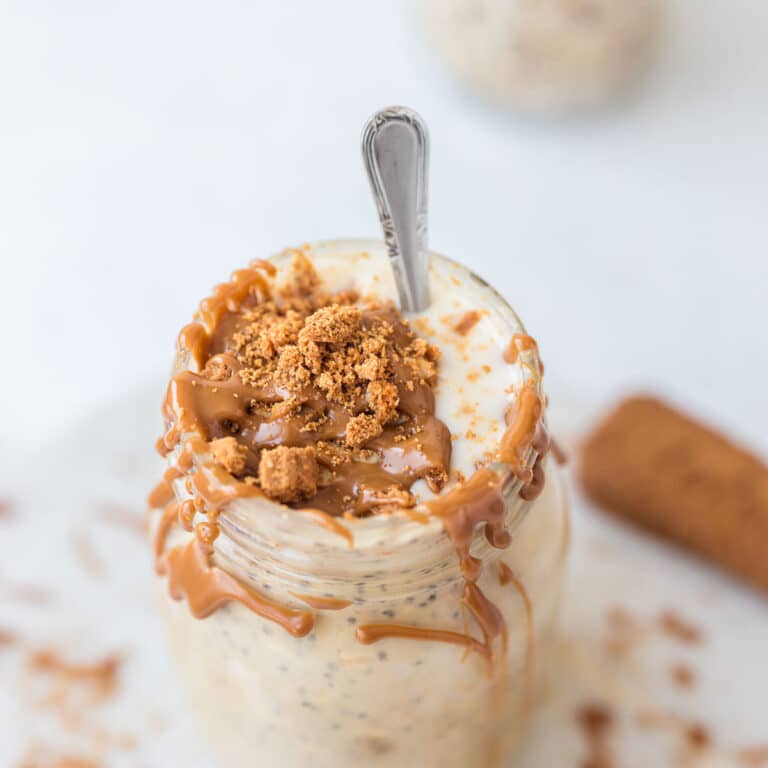 High Protein Biscoff Overnight Oats with cookie butter drizzle and crumbs on top ready to eat