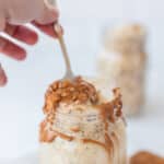 hand taking spoonful of High Protein Biscoff Overnight Oats