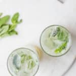 add lime juice, ice and sparkling water to mojito mocktail
