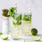 Classic mojito mocktails with fresh mint, lime slices, sparkling water, and ice