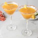 mango passionfruit mocktail garnished with mango spears