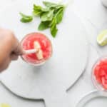 Muddling watermelon chunks, mint and lime for watermelon mojito