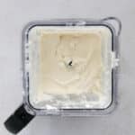 Frozen bananas, cottage cheese, yogurt, and Biscoff spread added to a blender to make high protein Biscoff ice cream.