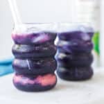Blue layer added to strawberry blueberry electrolyte mocktail recipe made with coconut water, strawberries, blueberries, and a pinch of sea salt.