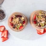 Dubai chocolate overnight oats topped with pistachio cream, crispy toasted kataifi, strawberries, and cacao nibs before chilling.