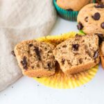 cooked greek yogurt chocolate chip muffins with one broken open to see texture inside