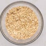 Dry ingredients for Homemade Chocolate Chip Granola Bars mixed in large glass mixing bowl