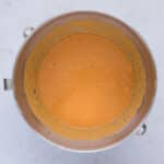 Pumpkin puree, Greek yogurt, egg whites, maple syrup, and applesauce being whisked together in a mixing bowl