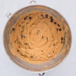 Healthy pumpkin chocolate chip muffin batter with chocolate chips folded in
