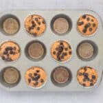 Pumpkin chocolate chip muffins topped with extra chocolate chips before baking