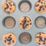 Healthy pumpkin chocolate chip muffin batter divided into parchment-lined muffin cups