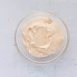 Cinnamon cream cheese frosting being mixed until smooth and creamy