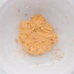 Soft pumpkin cinnamon roll dough mixed together in a bowl