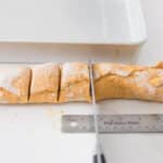 Pumpkin cinnamon roll dough rolled into a tight log and sliced into individual rolls before baking